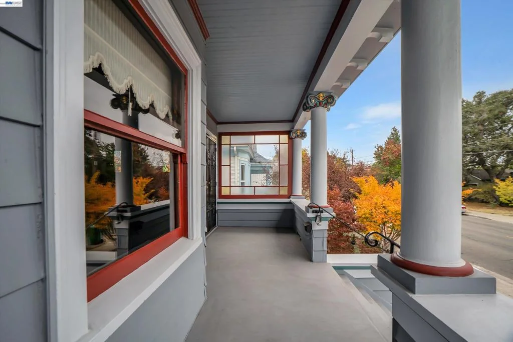 Covered front porch with red-trimmed windows at 2014 Buena Vista Avenue