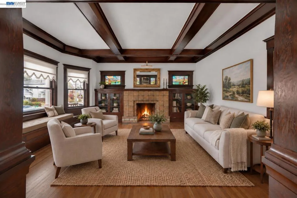 Living room with coffered ceiling, original woodwork, and stone fireplace
