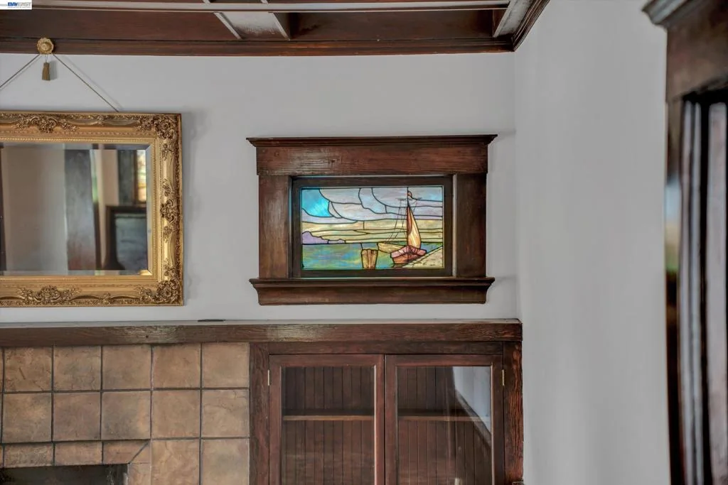 Living room fireplace and original built-in wood cabinetry