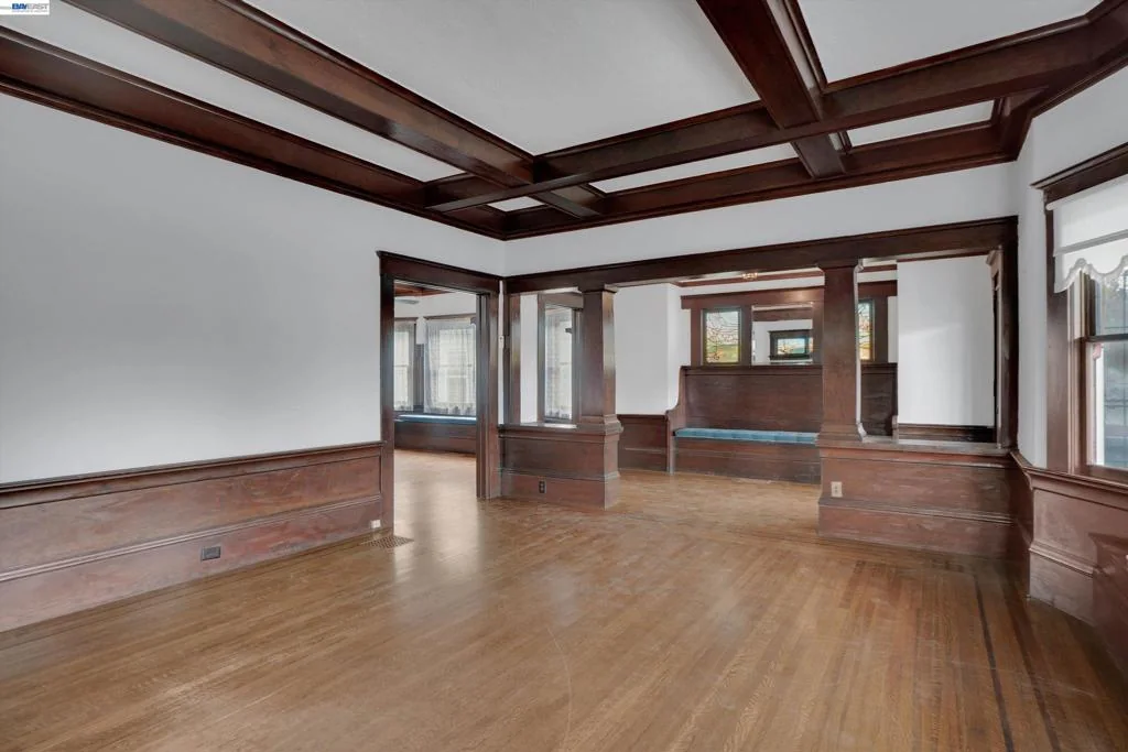 Living room opening to the dining room through wide pocket doors