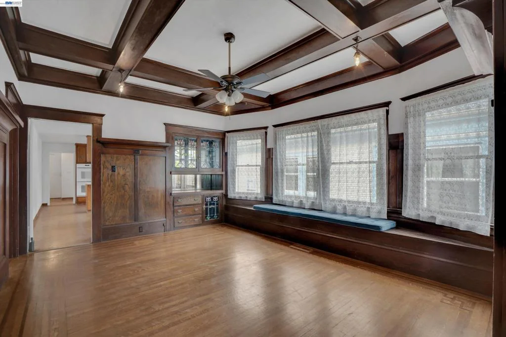 Open formal dining room with period trim and hardwood floor