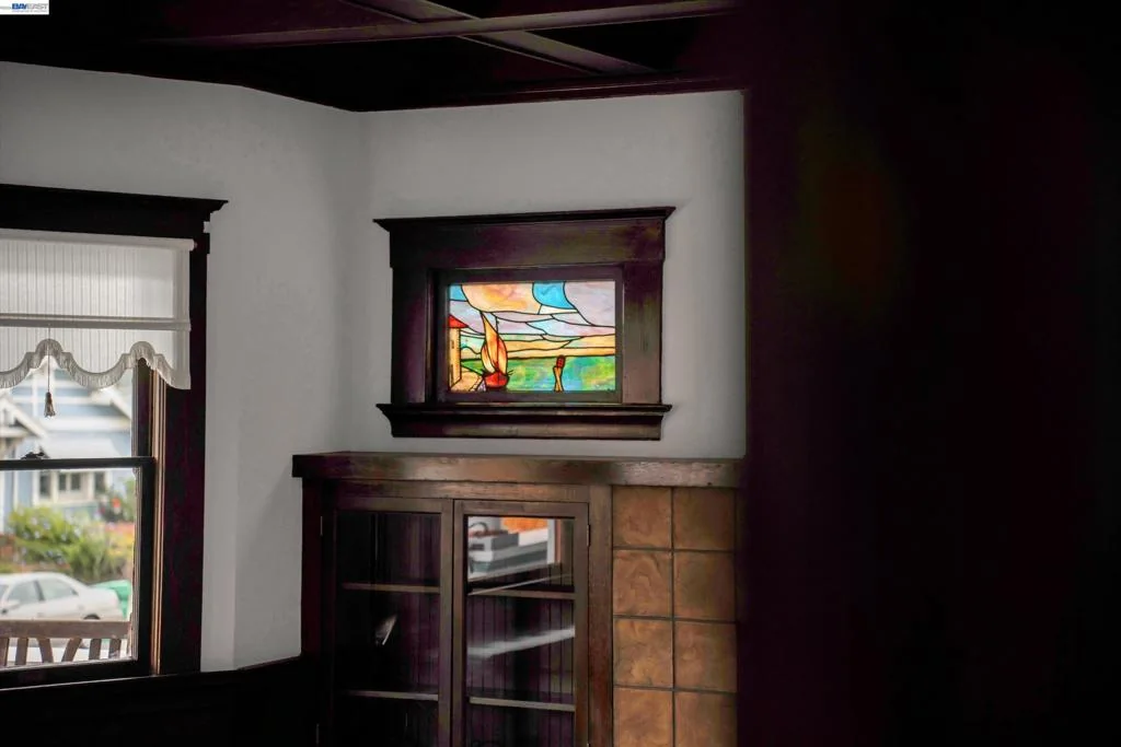 Original interior millwork and stained-glass accent near the living spaces