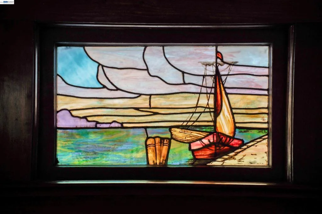 Original stained-glass window with a colorful sailboat motif