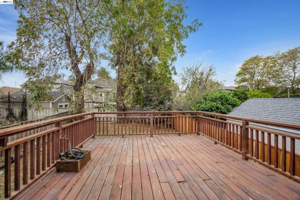 Large raised rear deck overlooking the fenced backyard